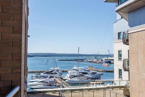 a group of boats are docked at a marina at Marina Secret - on Poole Quay with Free Parking in Poole
