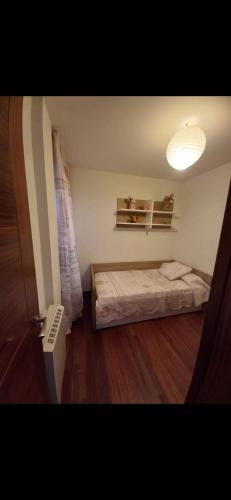 a small bedroom with a bed in a room at Gavor 68 in A Pobra do Caramiñal