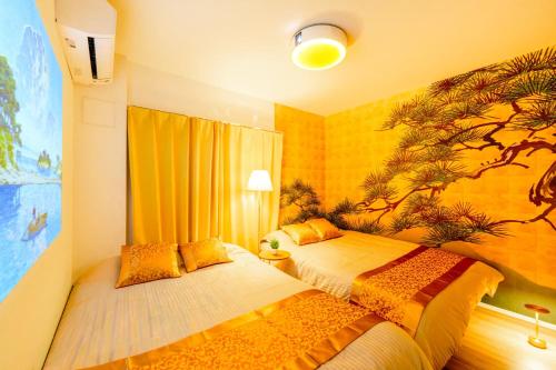 a bedroom with two beds and a painting on the wall at LEON RESORT HOTEL Max5-10people Sumiyoshi 8min Skytree 10min Kinshicho Taxi1meter in Tokyo