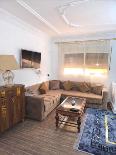a living room with a couch and a coffee table at إقامة الكرنيش in Nador