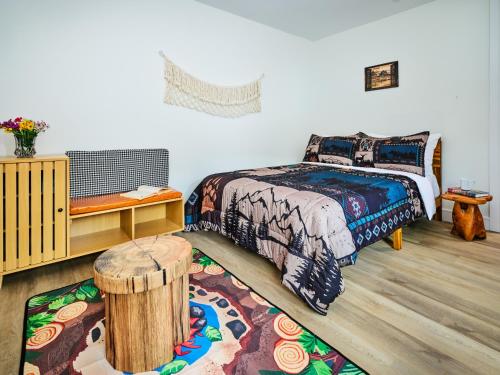 a bedroom with a bed and a wooden floor at Saddleview Bed & Breakfast in South Sterling