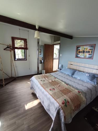 a bedroom with a large bed in a room at Cabaña en playa San Ignacio in Valdivia
