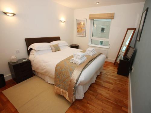 a bedroom with a large bed and a window at Marina Secret - on Poole Quay with Free Parking in Poole