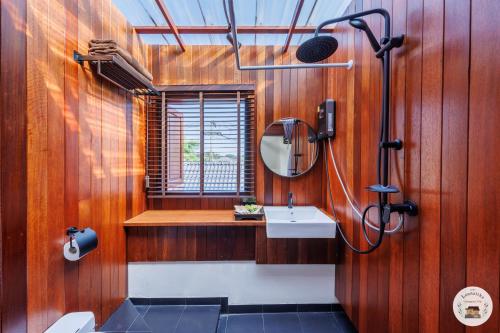 a bathroom with a sink and a mirror at Lannatika Villa in Chiang Mai
