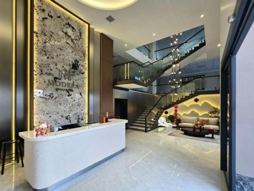 a lobby with a staircase and a living room at Modera Residence Grand Phnom Penh, Serviced Apartments in Phnom Penh
