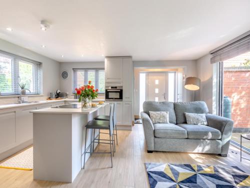 a living room with a couch and a kitchen at The Retreat - Uk45099 in Kirklington