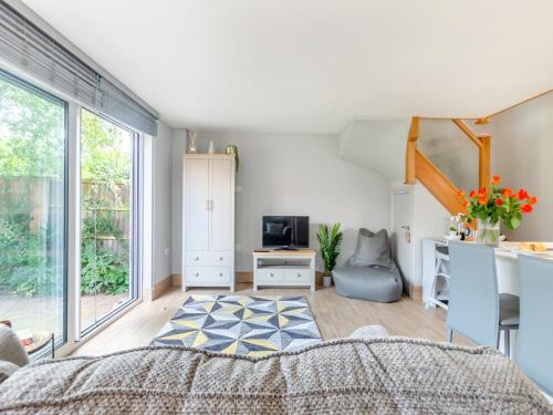 a bedroom with a bed and a desk with a television at The Retreat - Uk45099 in Kirklington