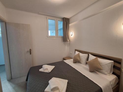 a bedroom with a bed with two towels on it at Villa Oxana in Limenas