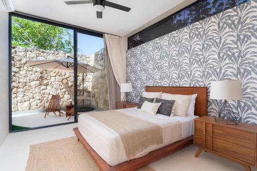 a bedroom with a bed and a large window at Limas in Tulum