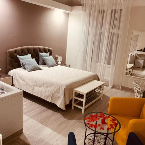 a bedroom with a bed and a couch and a chair at Due Delfini in Taranto