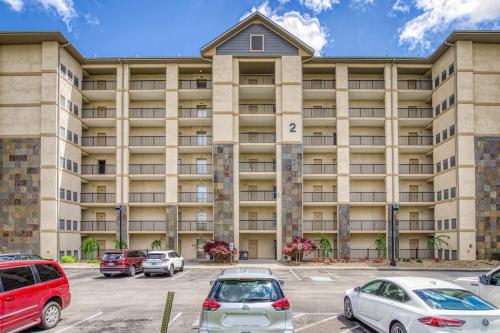 a large building with cars parked in a parking lot at Mountain View Condo by Beyond Expectations in Pigeon Forge
