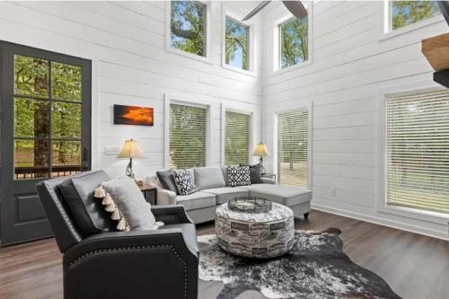 a living room with a couch and a table at Escape to Tranquility - Hot Tub - BBQ - Pets in Broken Bow