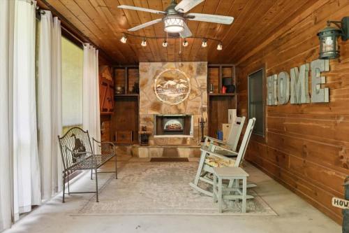 a living room with chairs and a fireplace at Chasing Cubs Cabin by Beyond Expectations in Sevierville