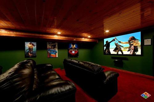 a living room with a couch and a flat screen tv at Paradise Pointe Pool Lodge by Beyond Expectations in Sevierville
