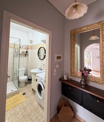 a bathroom with a washing machine and a mirror at The Stay in Igoumenitsa