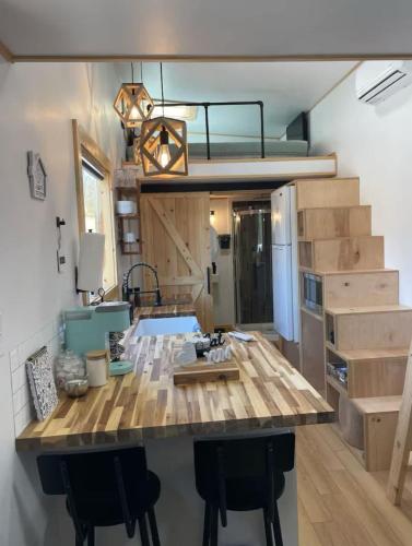 a kitchen with a large island with bar stools at Mountain Top Tiny House by Beyond Expectations in Waldens Creek