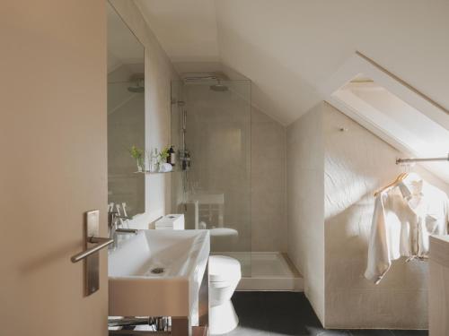 a bathroom with a white sink and a toilet at Casa Solayme Vitória in Lisbon