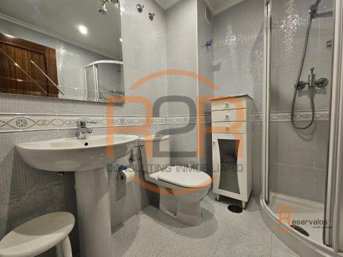 a bathroom with a sink and a toilet and a shower at R2R - El Raitán - 1A122 in Gijón