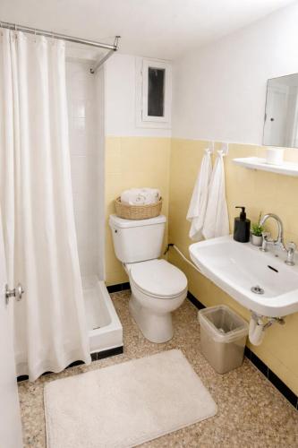 a bathroom with a toilet and a sink and a shower at Aioliana Apartments in Mytilene
