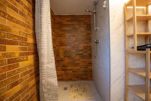 a bathroom with a brick wall and a shower at Space Comfort Bremen Apartment bis zu 5 Personen in Bremen
