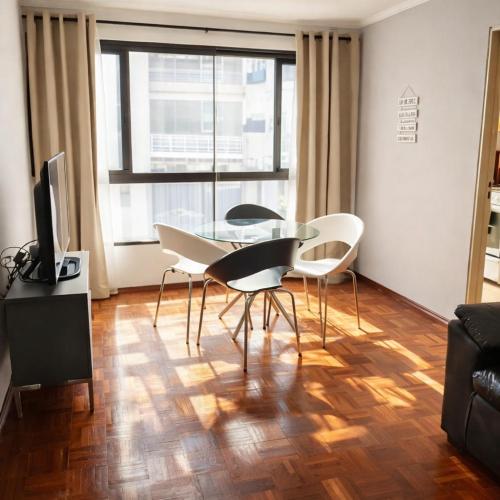a living room with a glass table and chairs at Departamento CBA in Córdoba