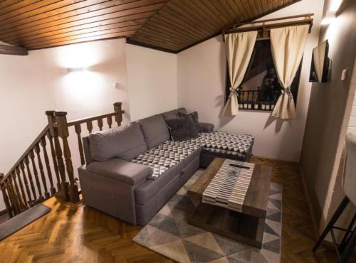 a living room with a couch and a coffee table at Belajec Wine & Nature Retreat in Veliko Brdo