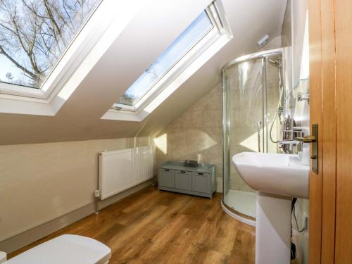 a bathroom with a sink and a skylight at Broadmoor Chapel in Hereford