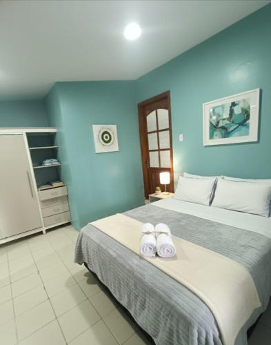 a bedroom with a large bed with two towels on it at Mini Bamboo Nest con Desayuno in Puyo