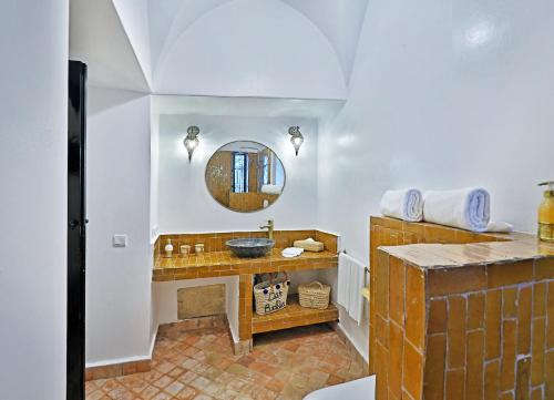 a bathroom with a sink and a mirror at Riad Dar Beldia and Spa in Marrakesh