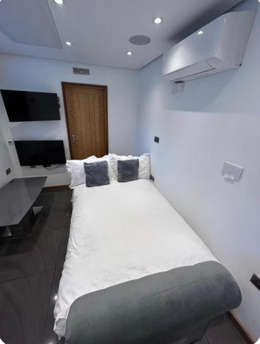 a bedroom with a large white bed in a room at Studio Guest House in Great Barr
