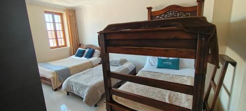 a bedroom with two bunk beds and a window at HOTEL El MONARCA in Tunja