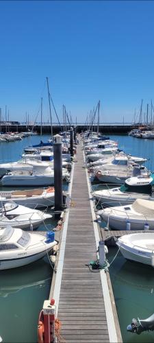 a bunch of boats are docked in the water at Veleiro Cozy Vintage in Lisbon