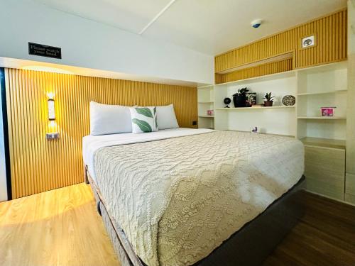 a bedroom with a large bed in a room at Loft2600 in Baguio