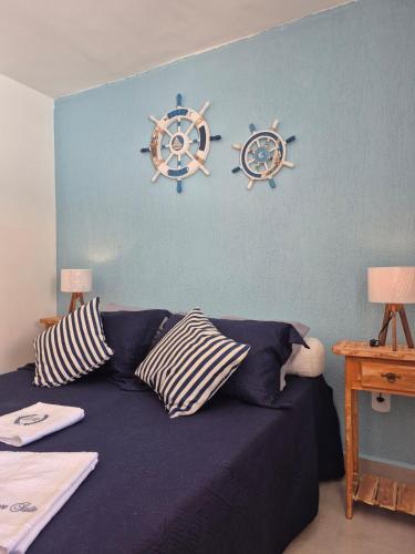 a bedroom with a bed with two anchors on the wall at Luz Residence beach house in Cabo Frio