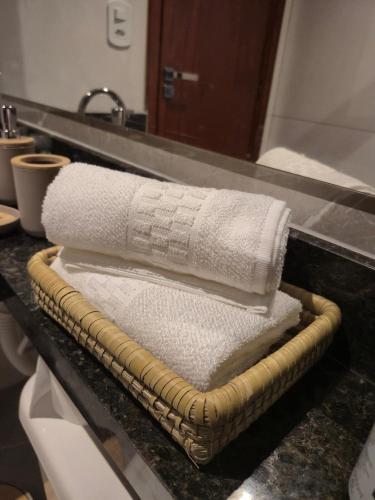 a pile of towels on a counter in a bathroom at Luz Residence beach house in Cabo Frio