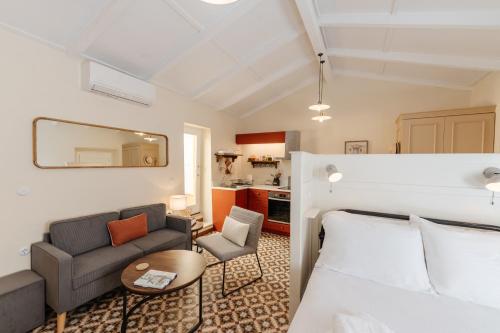 a living room with a bed and a couch at Kamari Guest House Corfu in Corfu International Airport I Kapodistrias