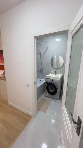 a bathroom with a tub and a toilet with a mirror at Aspan City Comfort 3 in Pokrovka