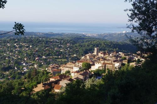 a town on a hill with houses and trees at Bed & Breakfast Les LILLAS in Saint-Jeannet