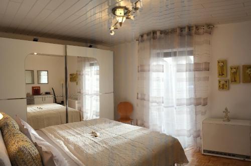 a bedroom with a large bed and a window at Lilie in Weilmünster