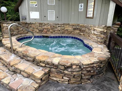 a large stone pool with a stone wall around it at Misty Mountain Condo by Beyond Expectations- 3BR Retreat with Scenic Views, Sleeps 8 & Near Ober Mountain in Gatlinburg