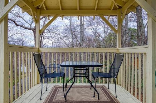 a screened porch with a table and two chairs at Bearly Makin It II by Beyond Expectations in Gatlinburg