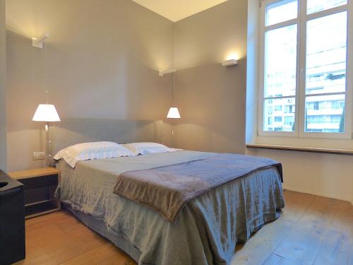 a bedroom with a bed and a large window at ALC - MOL4 - 8 min Palais in Cannes