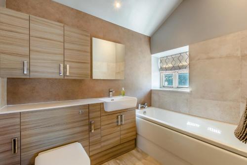 a bathroom with a sink and a bath tub at 2 Bed in Middleton oc-m29515 in Middleton
