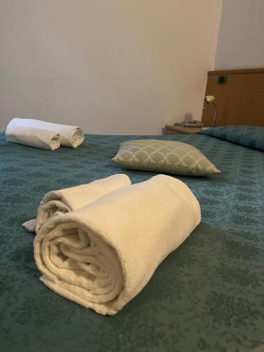 two beds with blankets and pillows on the floor at ALBERGO DELLA STAZIONE in Cairo Montenotte