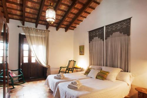a bedroom with two beds with towels on them at Casa Arizo, Hotel Boutique & Bike Friendly in Oropesa del Mar