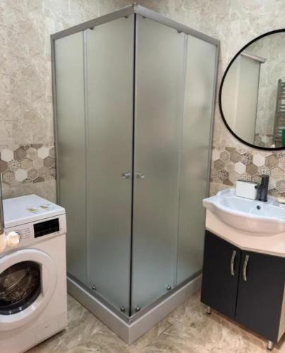 a bathroom with a washing machine and a sink at Sweet and New Apartment , Cit Center, Best Location in Yerevan