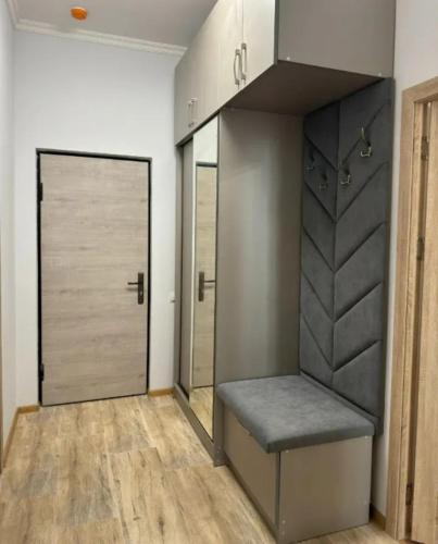 a room with a bench and a closet with mirrors at Sweet and New Apartment , Cit Center, Best Location in Yerevan