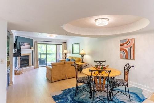 a living room with a table and chairs and a couch at Gatehouse Condo by Beyond Expectations w Views in Gatlinburg