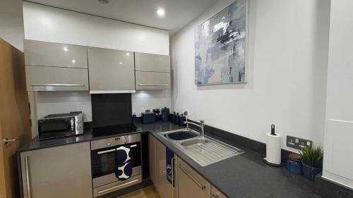 a kitchen with a sink and a counter top at Chic Studio near Canary Wharf in London