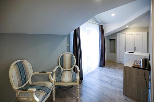 a living room with two chairs and a window at Doa Suite Hotel in Trabzon